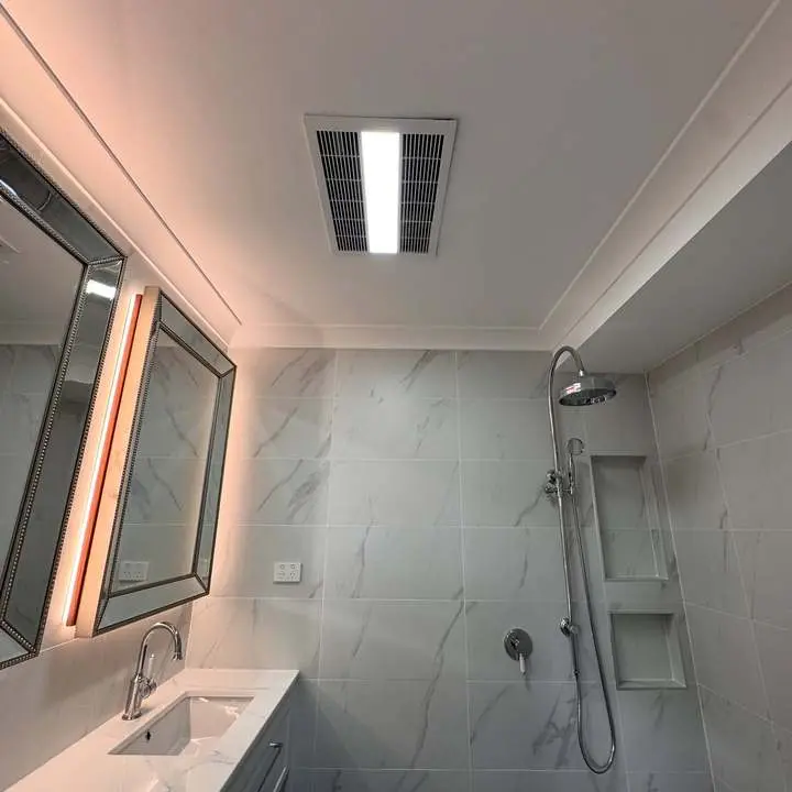 Renovated bathroom with exhaust fan and lighting by BPE Solutions