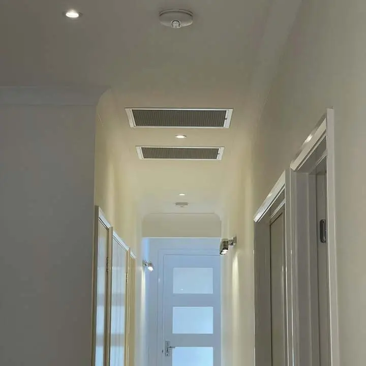 Hallway ceiling where smoke alarms and downlights are installed