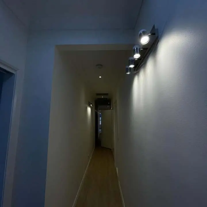 Wall lights along a long hallway