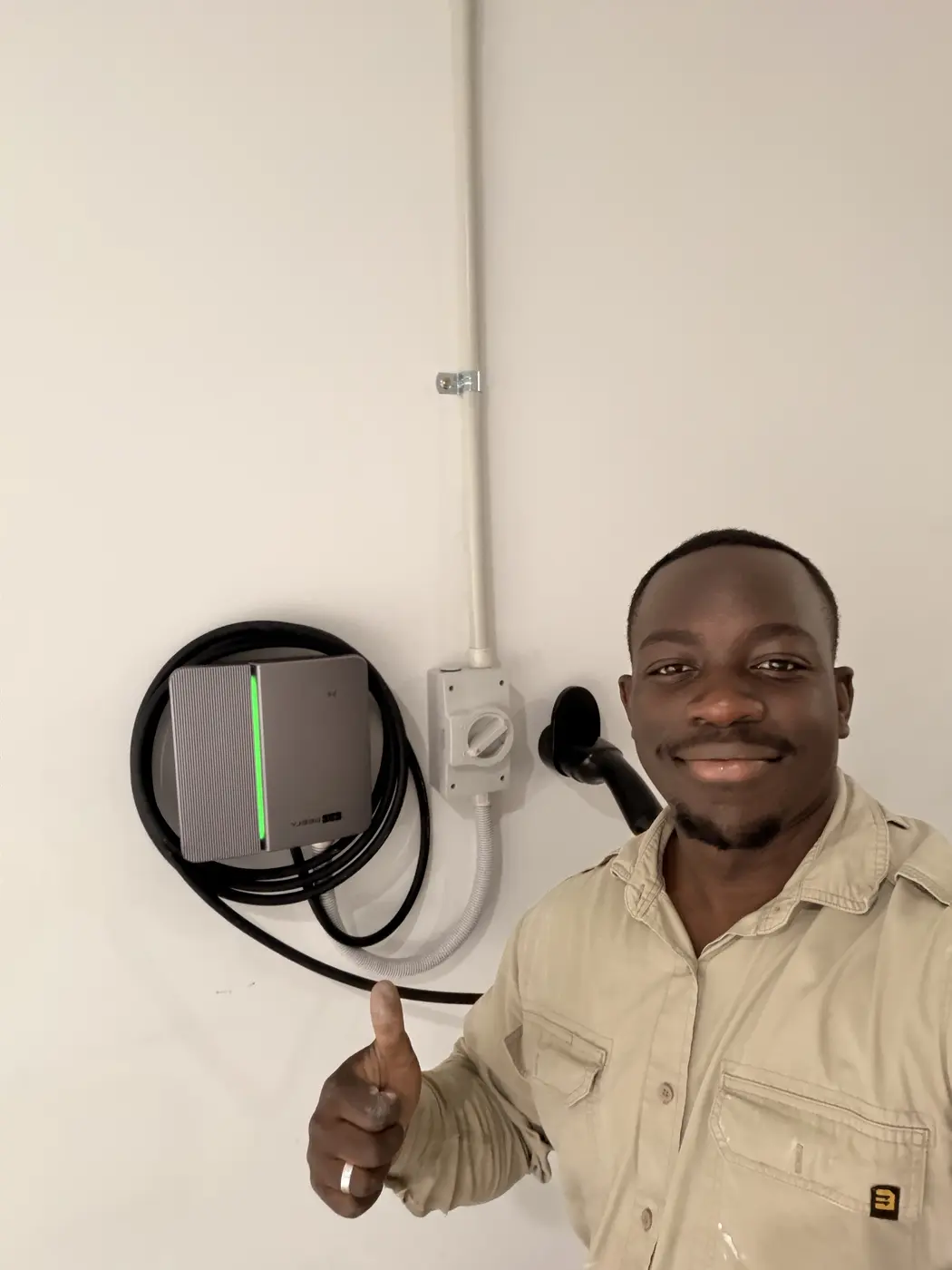 Mutsa, owner and electrician at BPE Solutions, with a home EV charger he installed